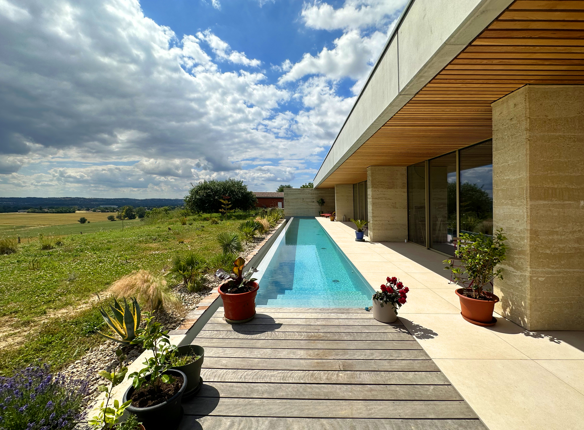 Vue sur la piscine filante et des débords du toit pour le confort d’été . 